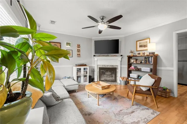 a living room with furniture a fireplace and a flat screen tv
