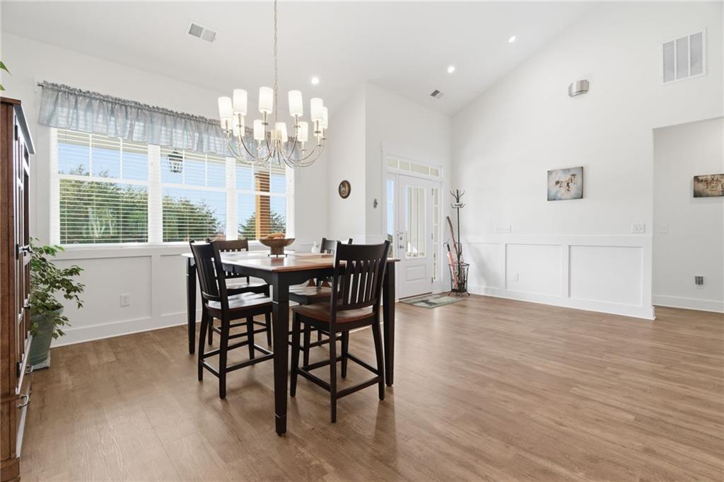 760 Stoneledge Road Jasper, GA 30143 - Photo 12 of 68 a view of a dining room with furniture a chandelier and wooden floor