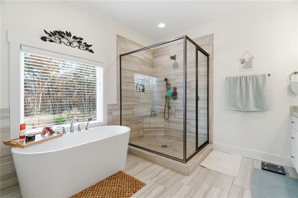 760 Stoneledge Road Jasper, GA 30143 - Photo 18 of 68 a bathroom with a bathtub and a shower