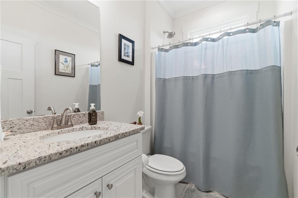 760 Stoneledge Road Jasper, GA 30143 - Photo 24 of 68 a bathroom with a granite countertop sink and a mirror