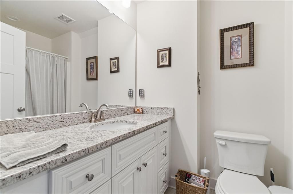 760 Stoneledge Road Jasper, GA 30143 - Photo 28 of 68 a bathroom with a granite countertop sink and a toilet