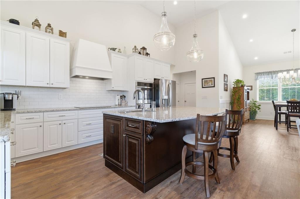 760 Stoneledge Road Jasper, GA 30143 - Photo 5 of 68 a kitchen with stainless steel appliances granite countertop a table chairs sink and cabinets