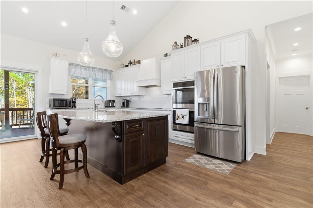 760 Stoneledge Road Jasper, GA 30143 - Photo 7 of 68 a kitchen with a refrigerator a white table and chairs