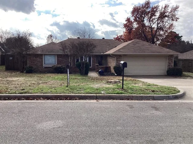 a house that has a tree in front of it