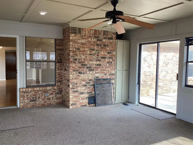 a furnished livingroom with windows and chandelier