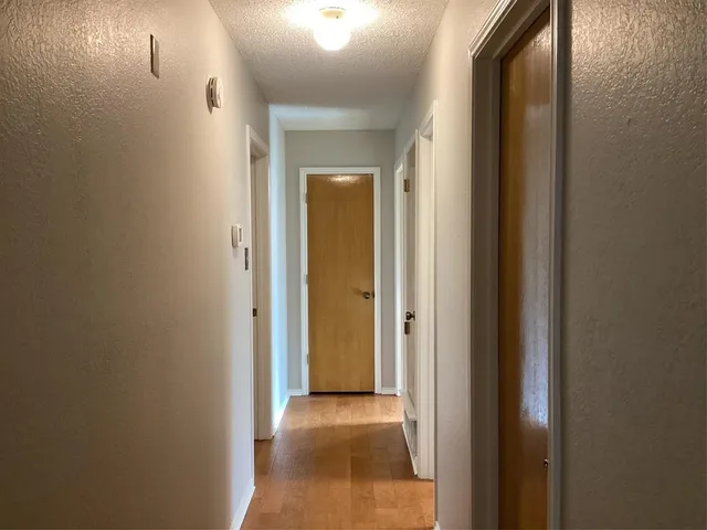 a view of a hallway with a wooden door