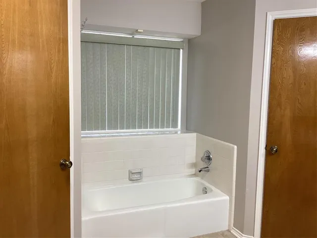 a white bath tub and shower