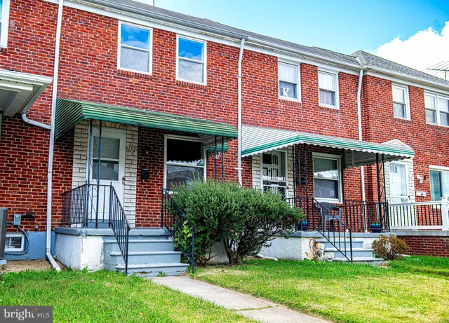 front view of brick house with a yard