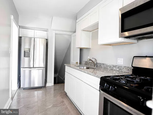 a kitchen with stainless steel appliances a sink a stove and a refrigerator
