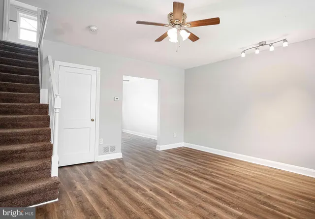 wooden floor in an empty room with a window