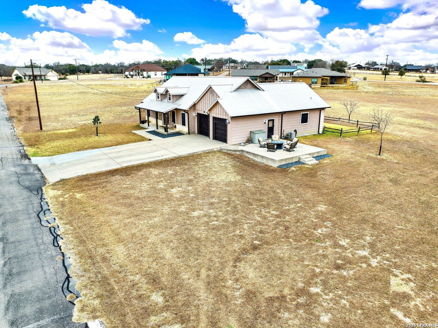 445 Spanish Grant Circle Bandera, TX 78003 - Photo 12 of 47 a view of a lake with a lawn chairs and a table with chairs