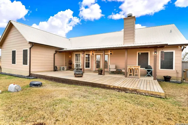 a view of a house with swimming pool and sitting area