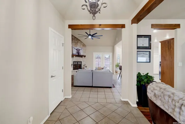 a living room with furniture and a chandelier