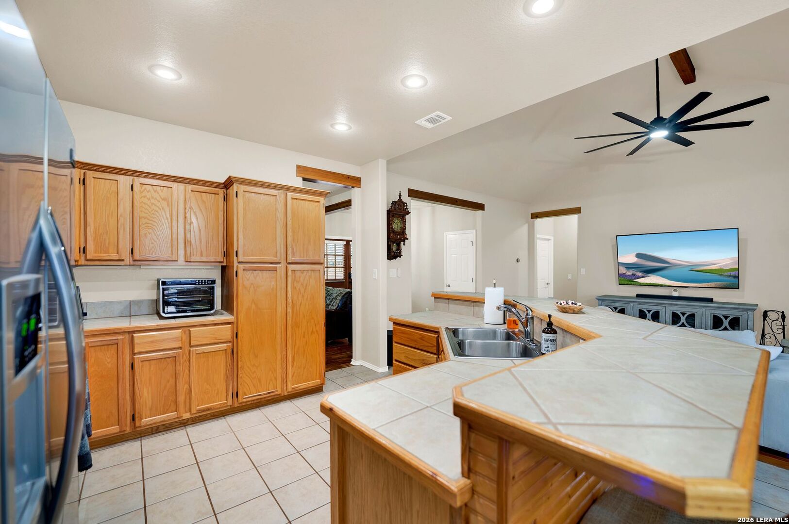 445 Spanish Grant Circle Bandera, TX 78003 - Photo 26 of 47 a kitchen with stainless steel appliances a stove refrigerator sink and microwave