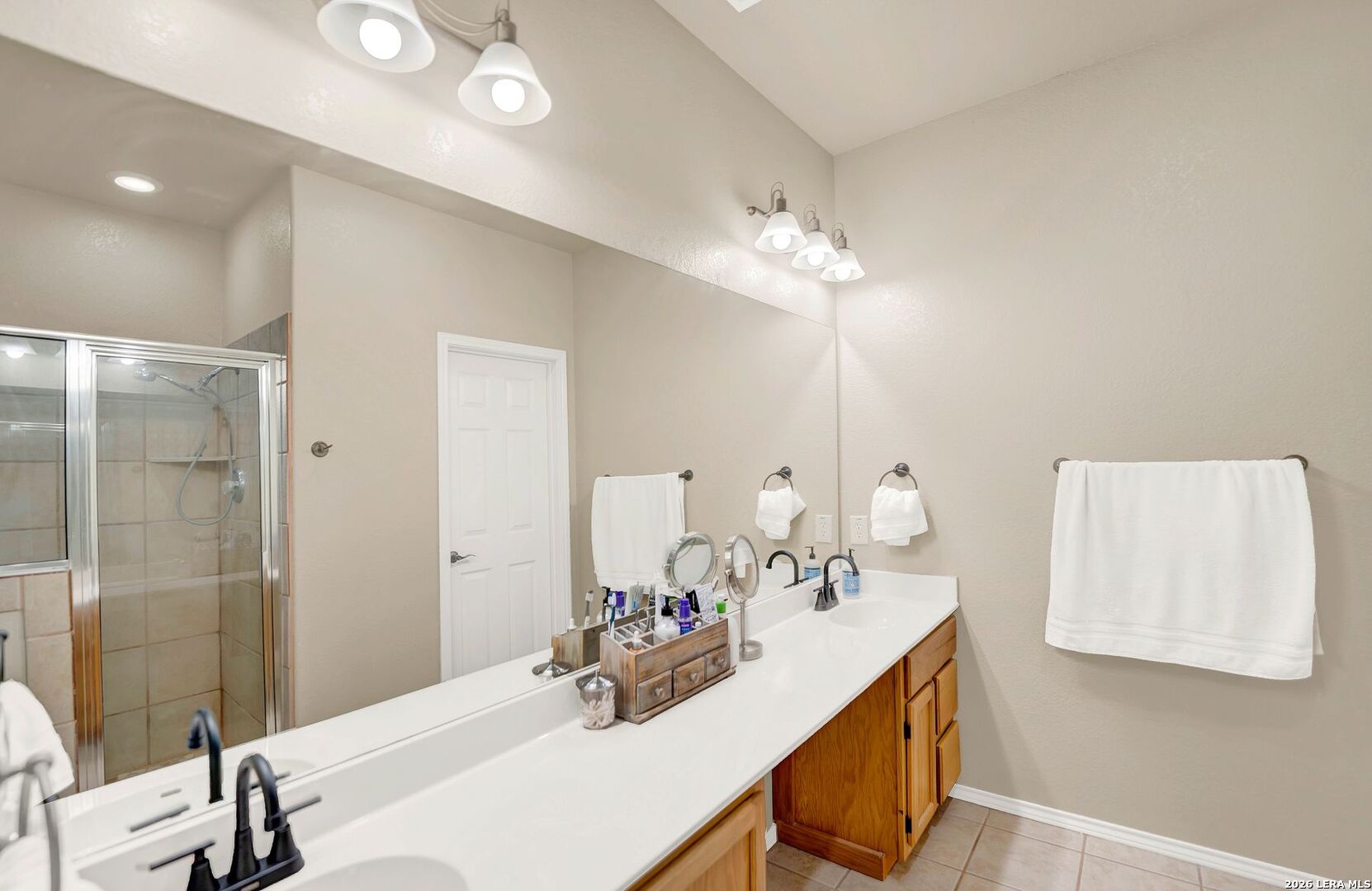 445 Spanish Grant Circle Bandera, TX 78003 - Photo 35 of 47 a bathroom with a double vanity sink mirror and