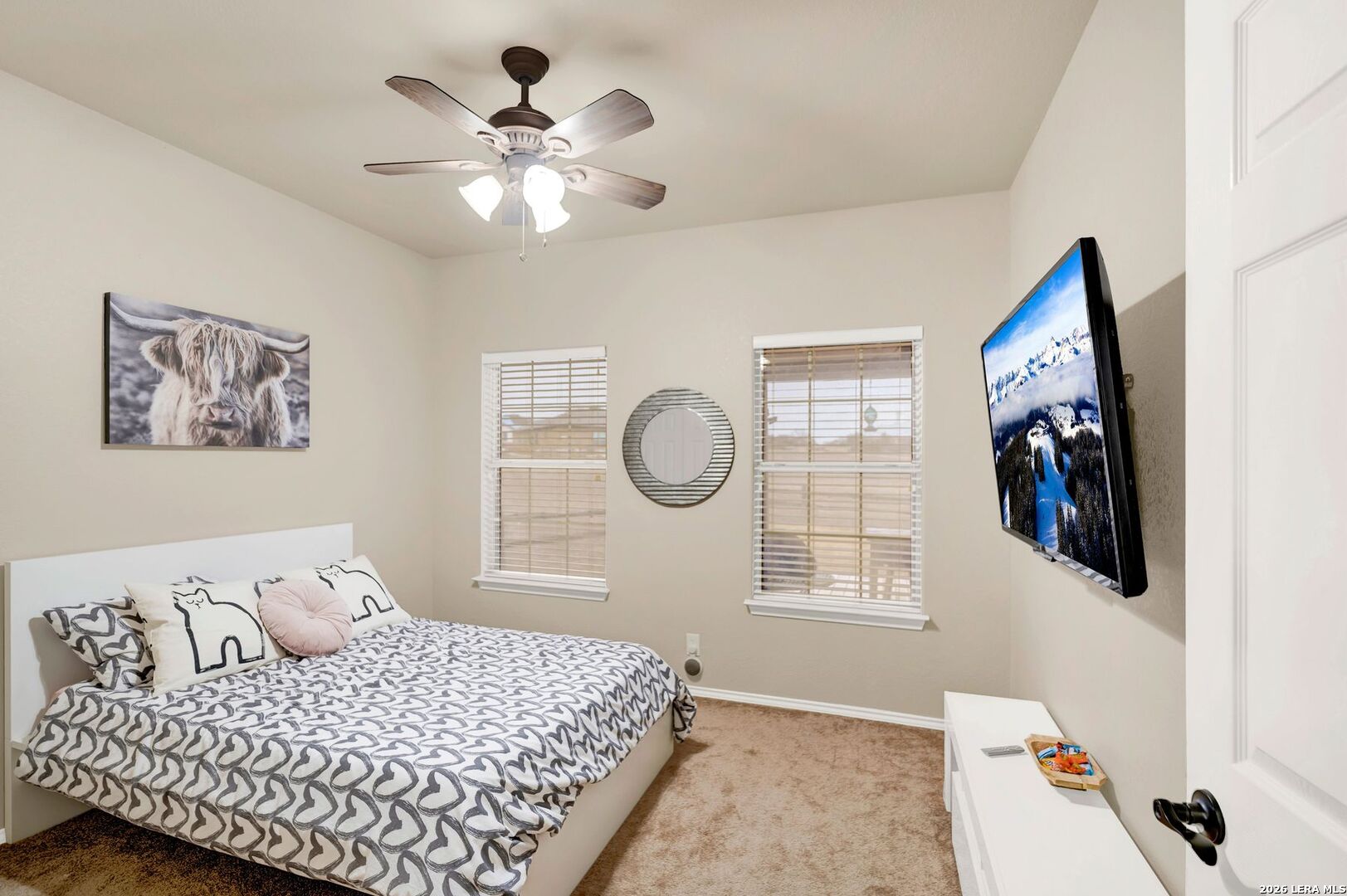 445 Spanish Grant Circle Bandera, TX 78003 - Photo 39 of 47 a bedroom with a large bed and a chandelier