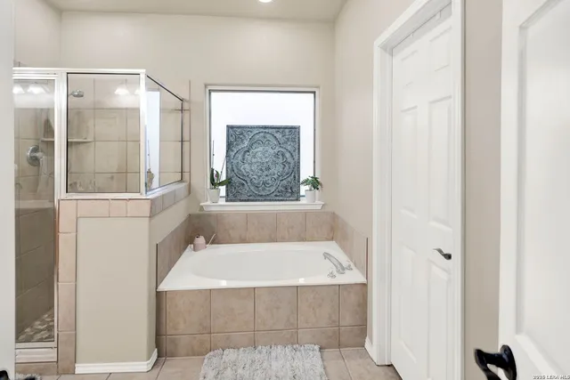 a bathroom with a tub and shower