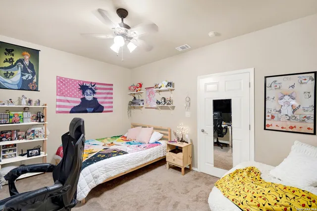 a bedroom with a bed and a chandelier