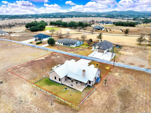 an aerial view of a house with a ocean view