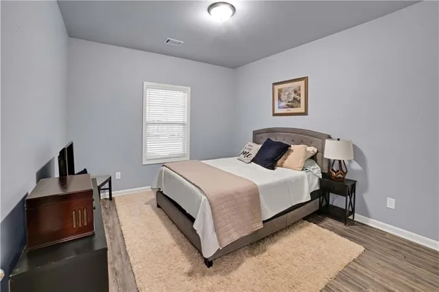 a bedroom with a bed and night stand