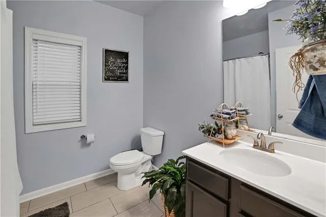 a bathroom with a sink toilet and a mirror