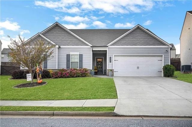 a front view of a house with a yard and garage