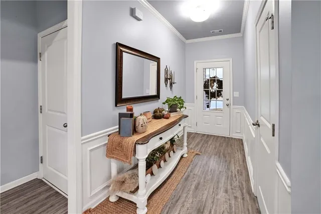 a view of a hallway and a livingroom with wooden floor