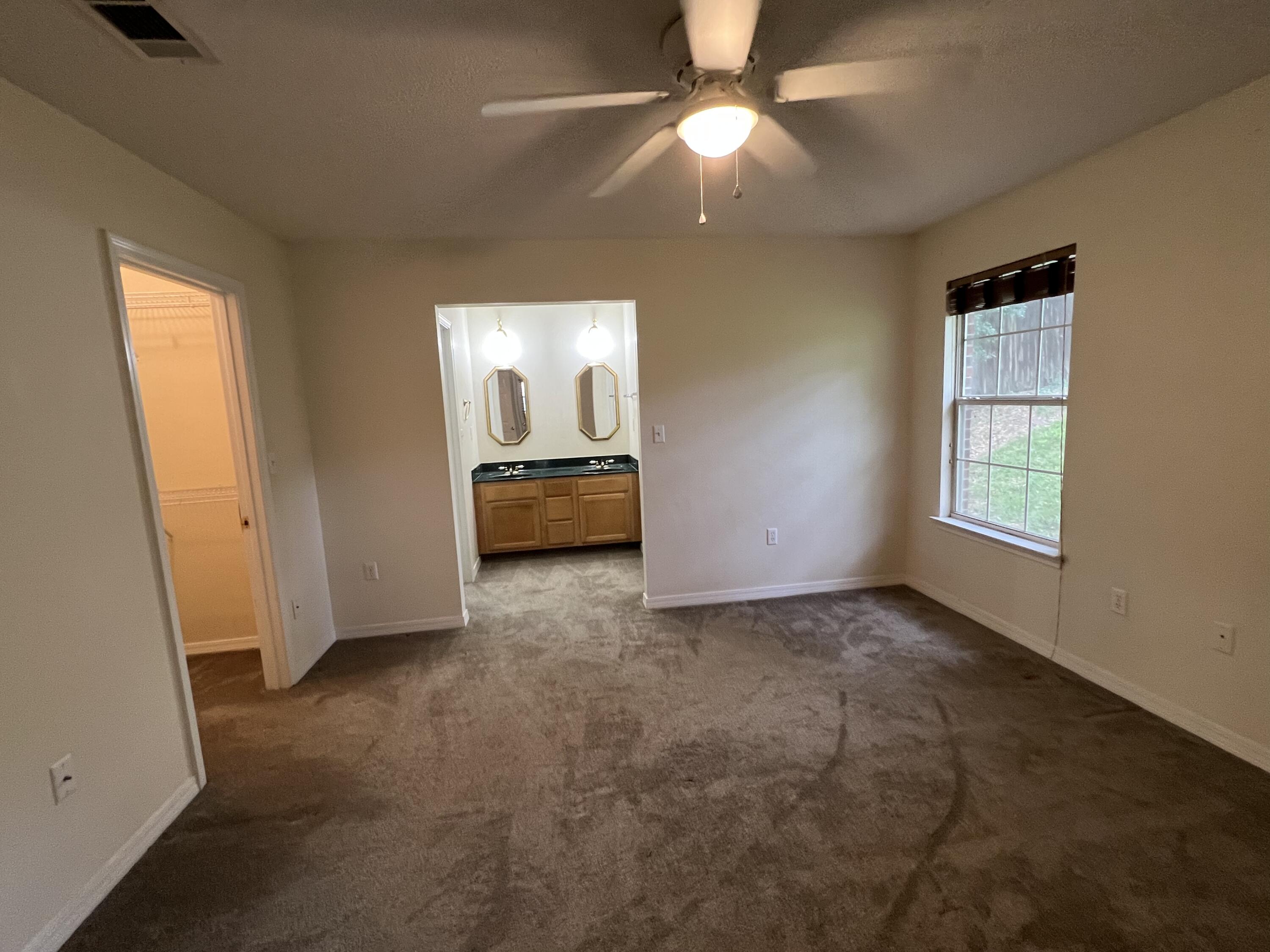 4443 Antioch Road Crestview, FL 32536 - Photo 11 of 24 an empty room with windows and fan