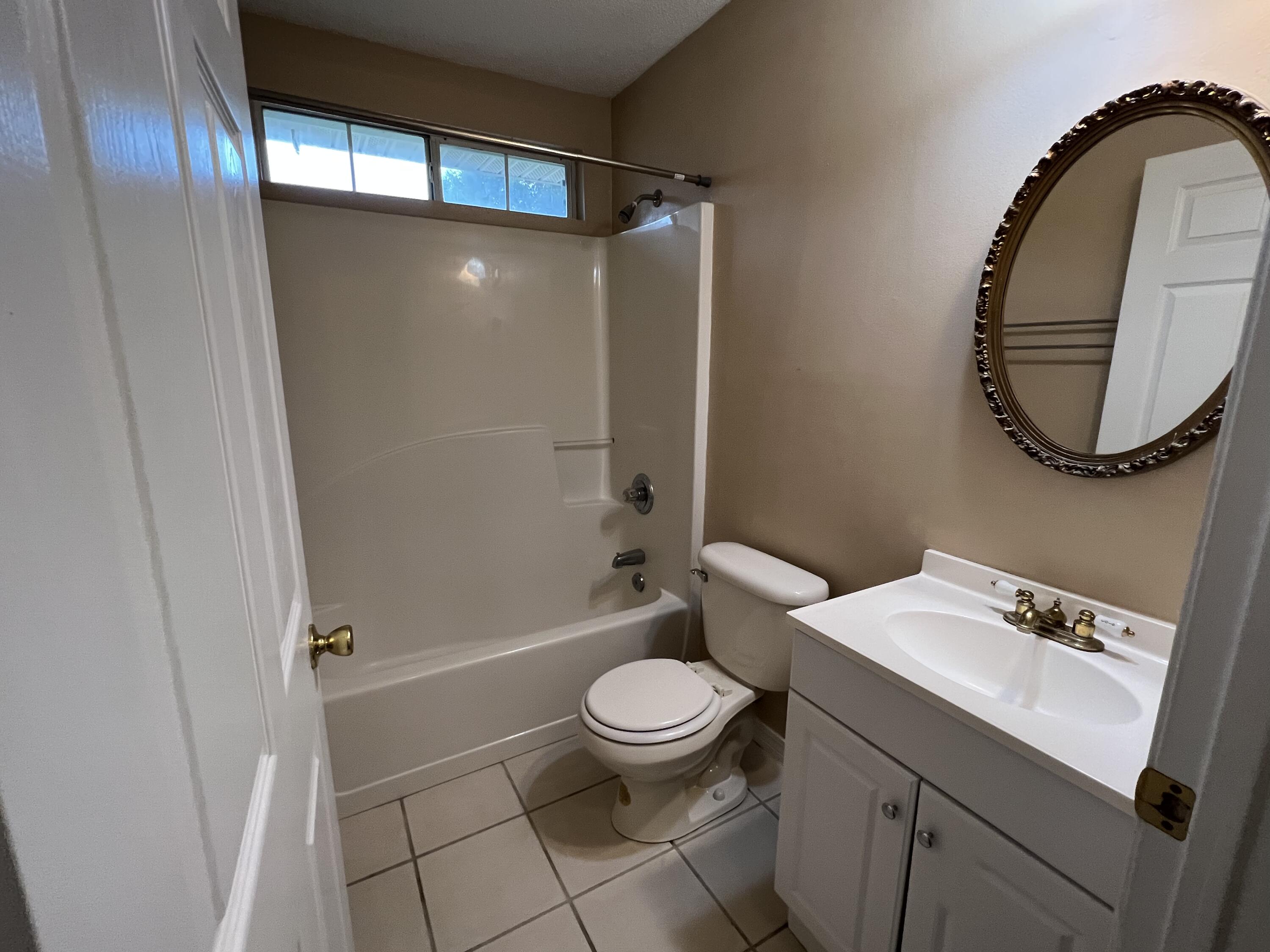 4443 Antioch Road Crestview, FL 32536 - Photo 16 of 24 a bathroom with a sink toilet and shower