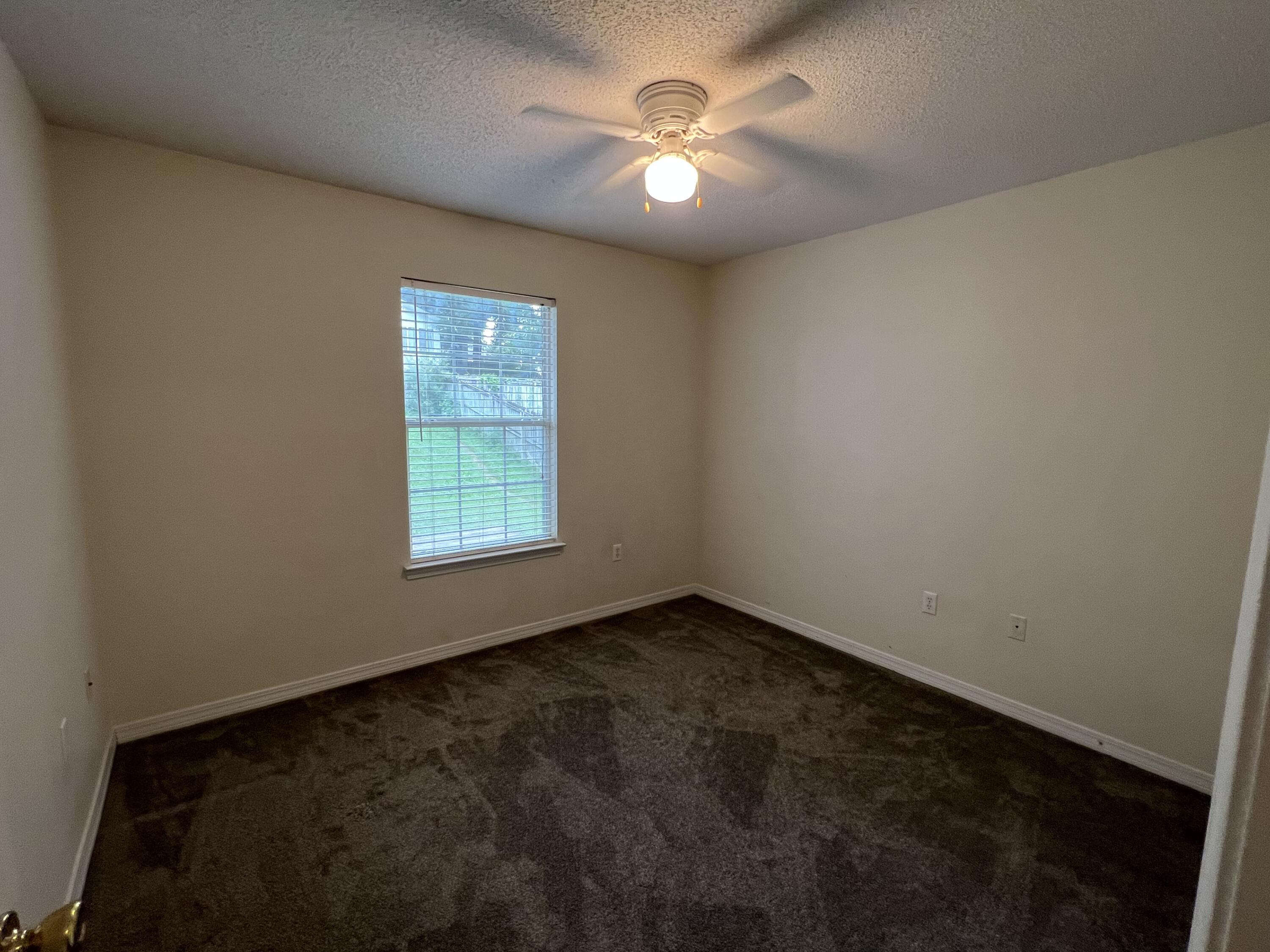 4443 Antioch Road Crestview, FL 32536 - Photo 17 of 24 an empty room with a window and a fan