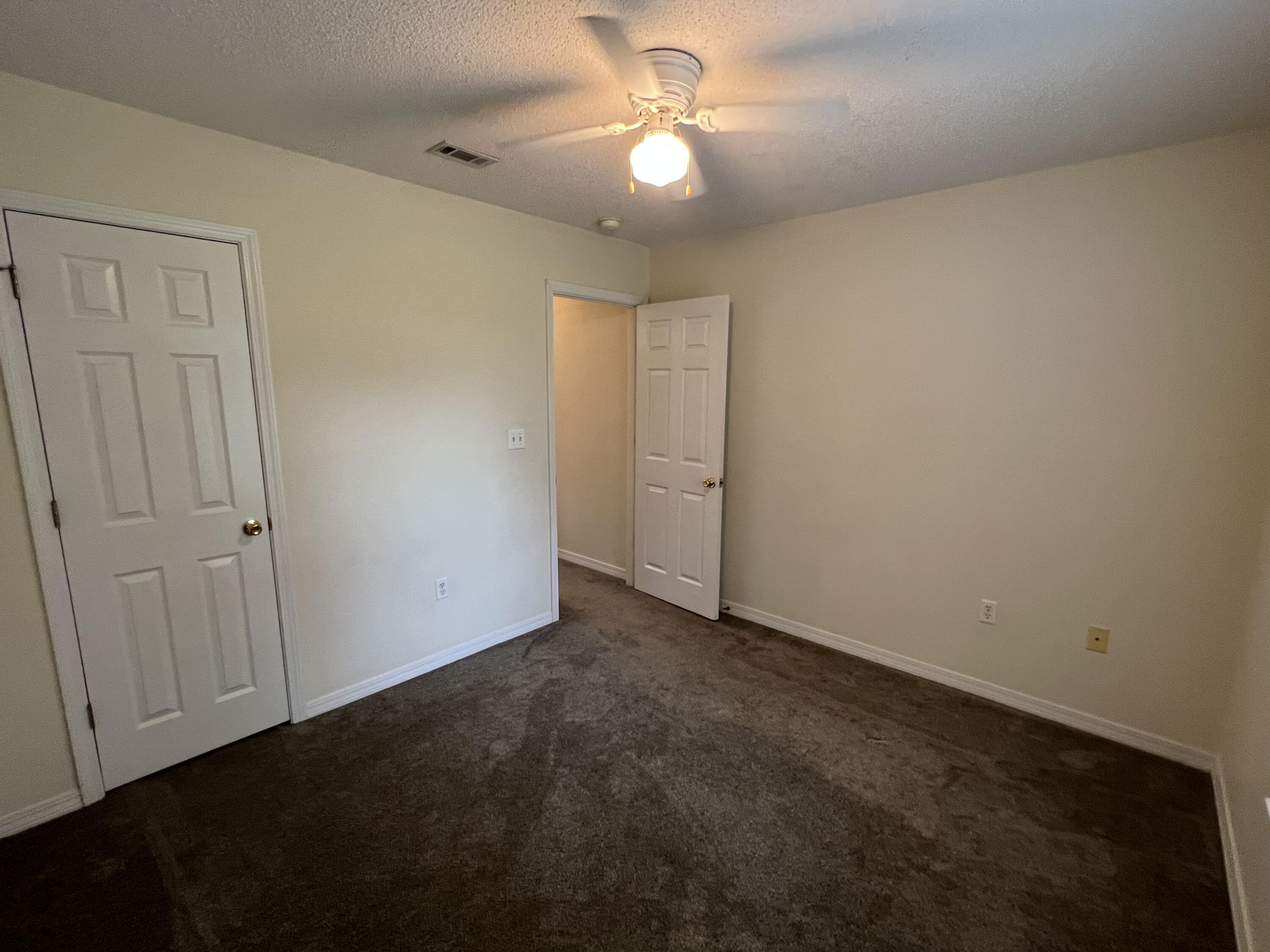 4443 Antioch Road Crestview, FL 32536 - Photo 18 of 24 an empty room with closet and a ceiling fan