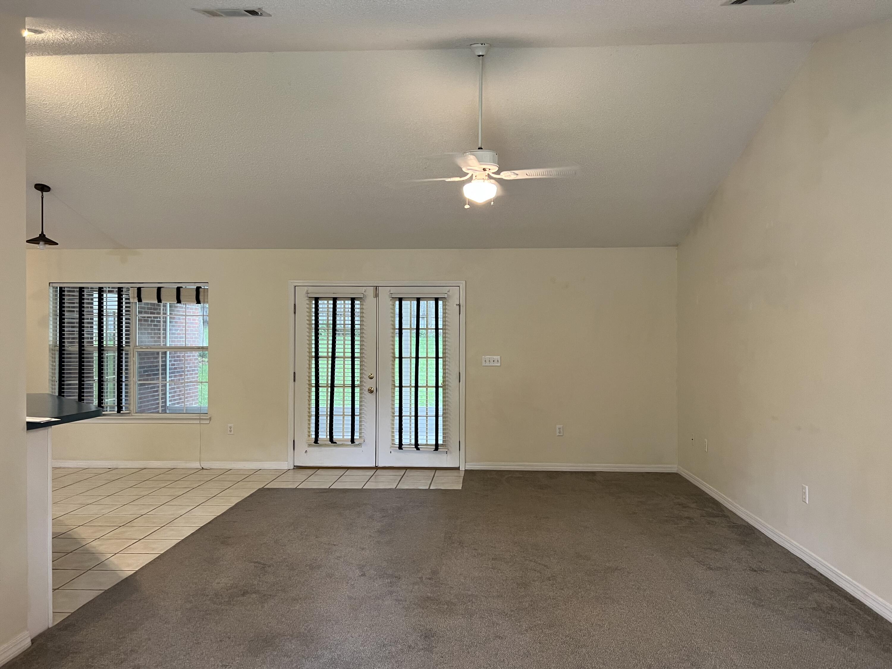 4443 Antioch Road Crestview, FL 32536 - Photo 2 of 24 wooden floor in an empty room with a window