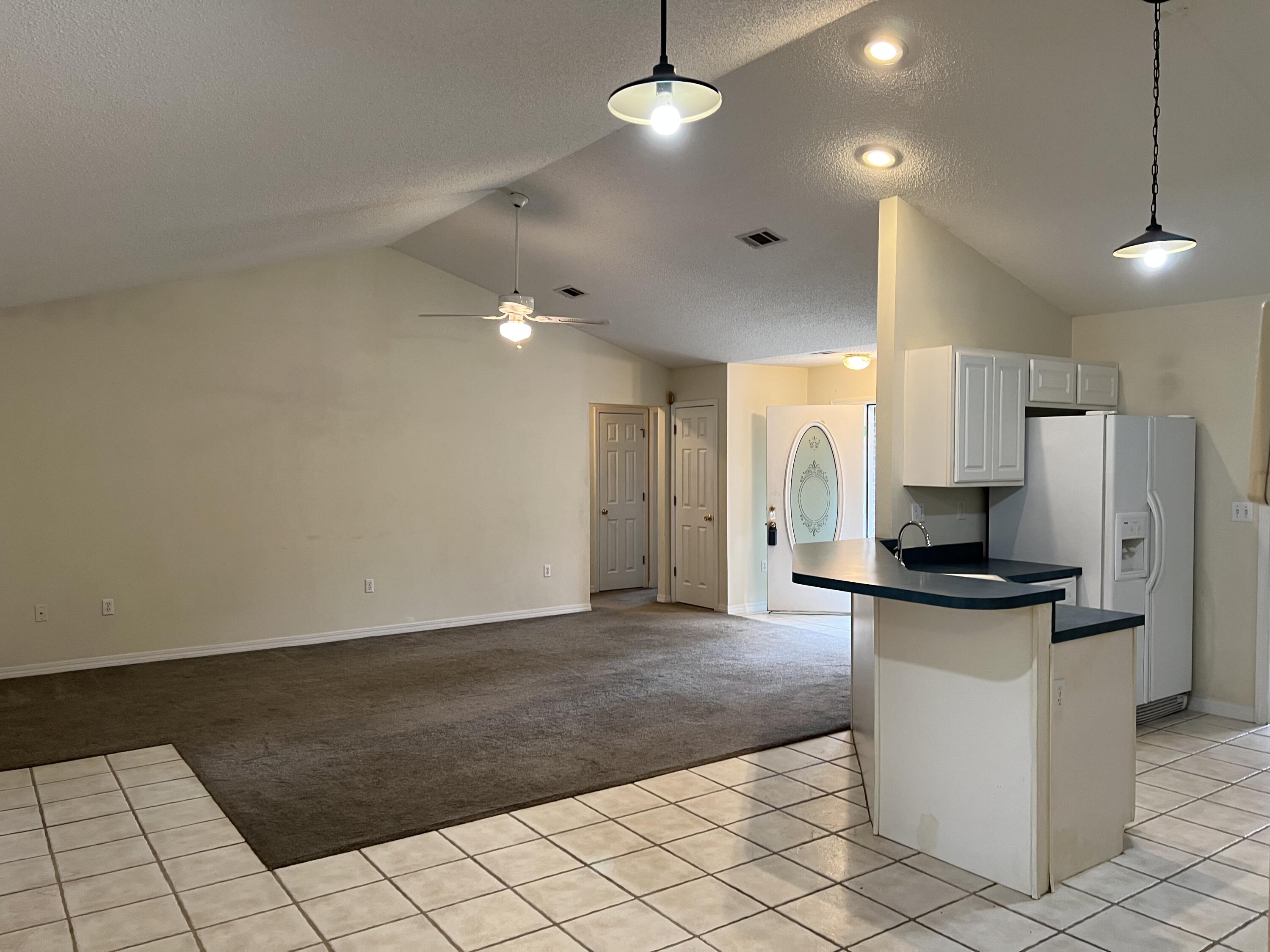 4443 Antioch Road Crestview, FL 32536 - Photo 3 of 24 a kitchen with granite countertop a stove and a refrigerator