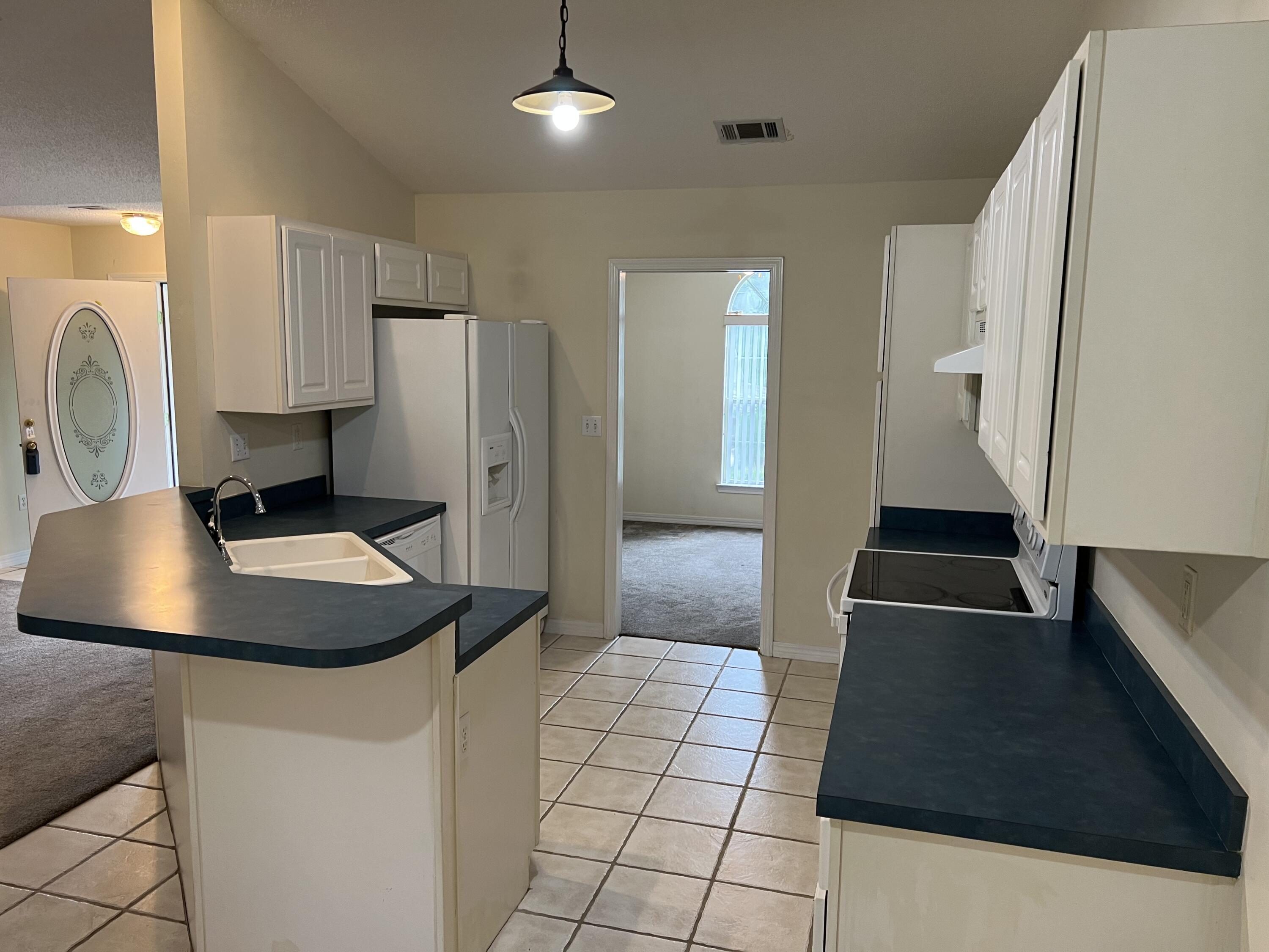 4443 Antioch Road Crestview, FL 32536 - Photo 4 of 24 a kitchen with stainless steel appliances a sink a stove a refrigerator and cabinets