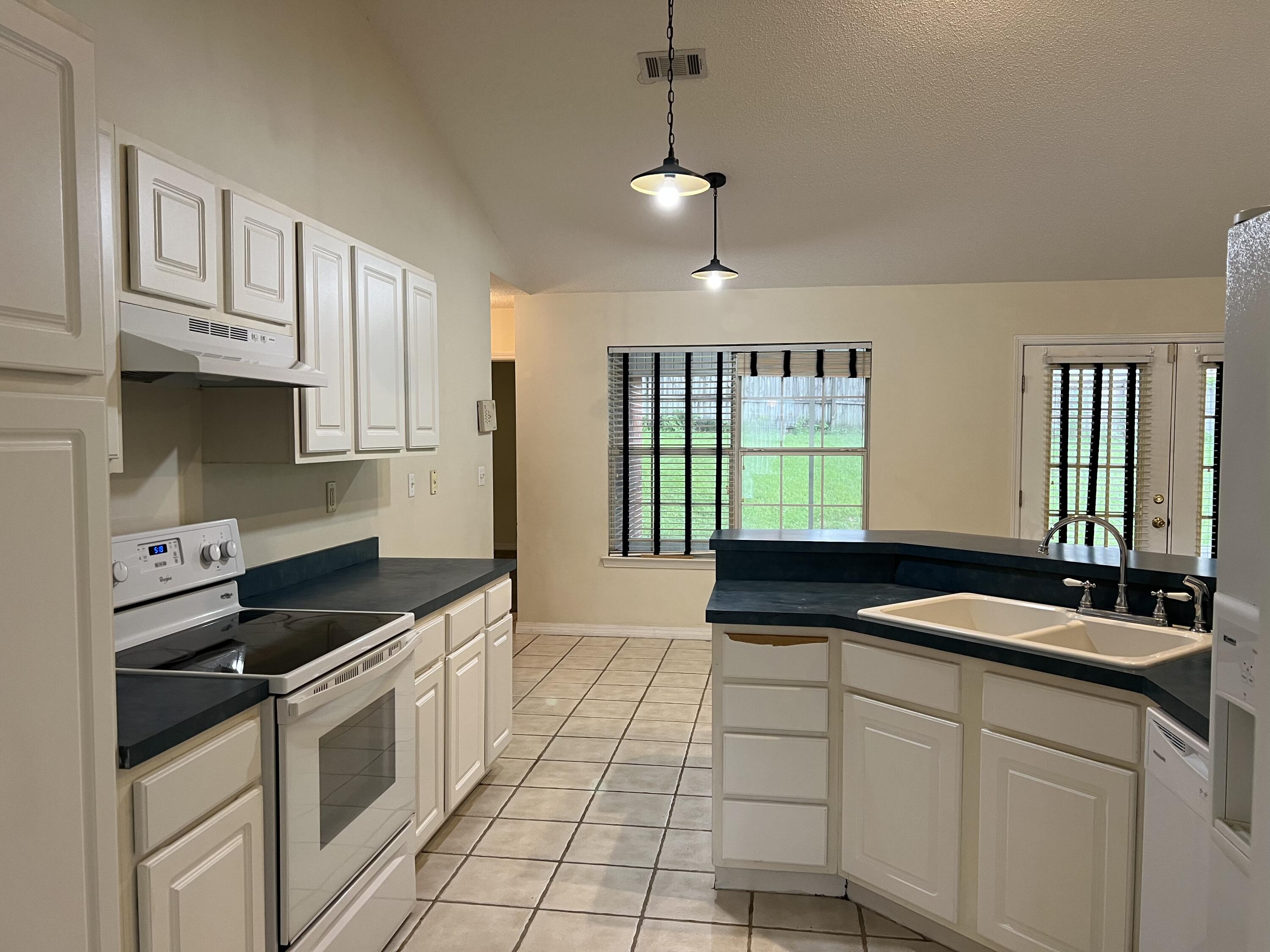 4443 Antioch Road Crestview, FL 32536 - Photo 6 of 24 a kitchen with stainless steel appliances granite countertop a sink and a stove