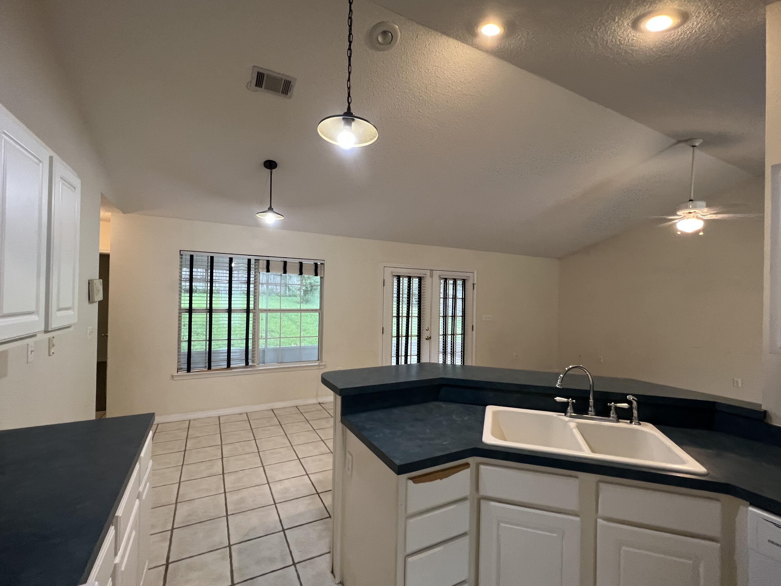 4443 Antioch Road Crestview, FL 32536 - Photo 7 of 24 a kitchen with a sink and a large window