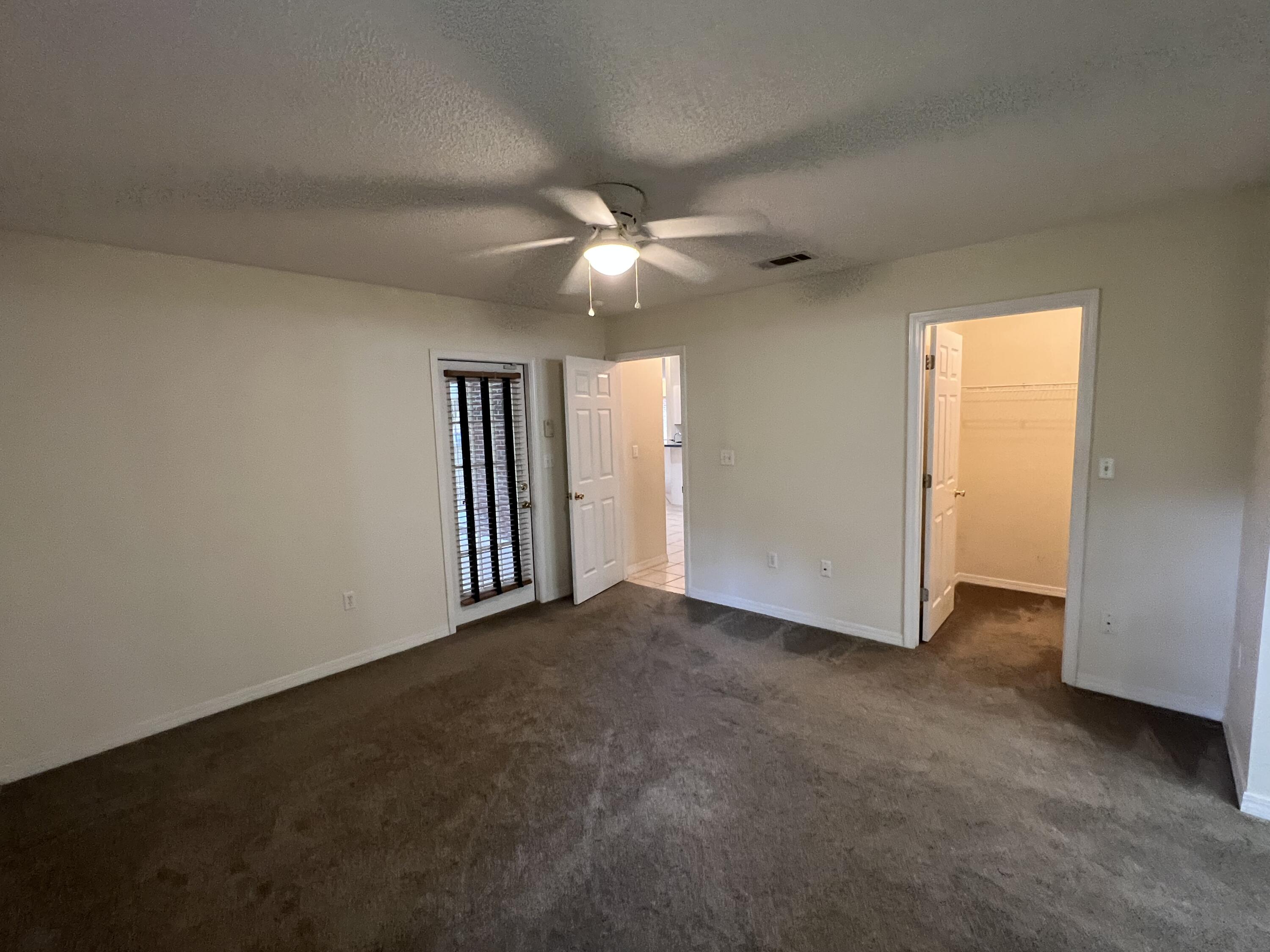 4443 Antioch Road Crestview, FL 32536 - Photo 9 of 24 an empty room with closet and a ceiling fan