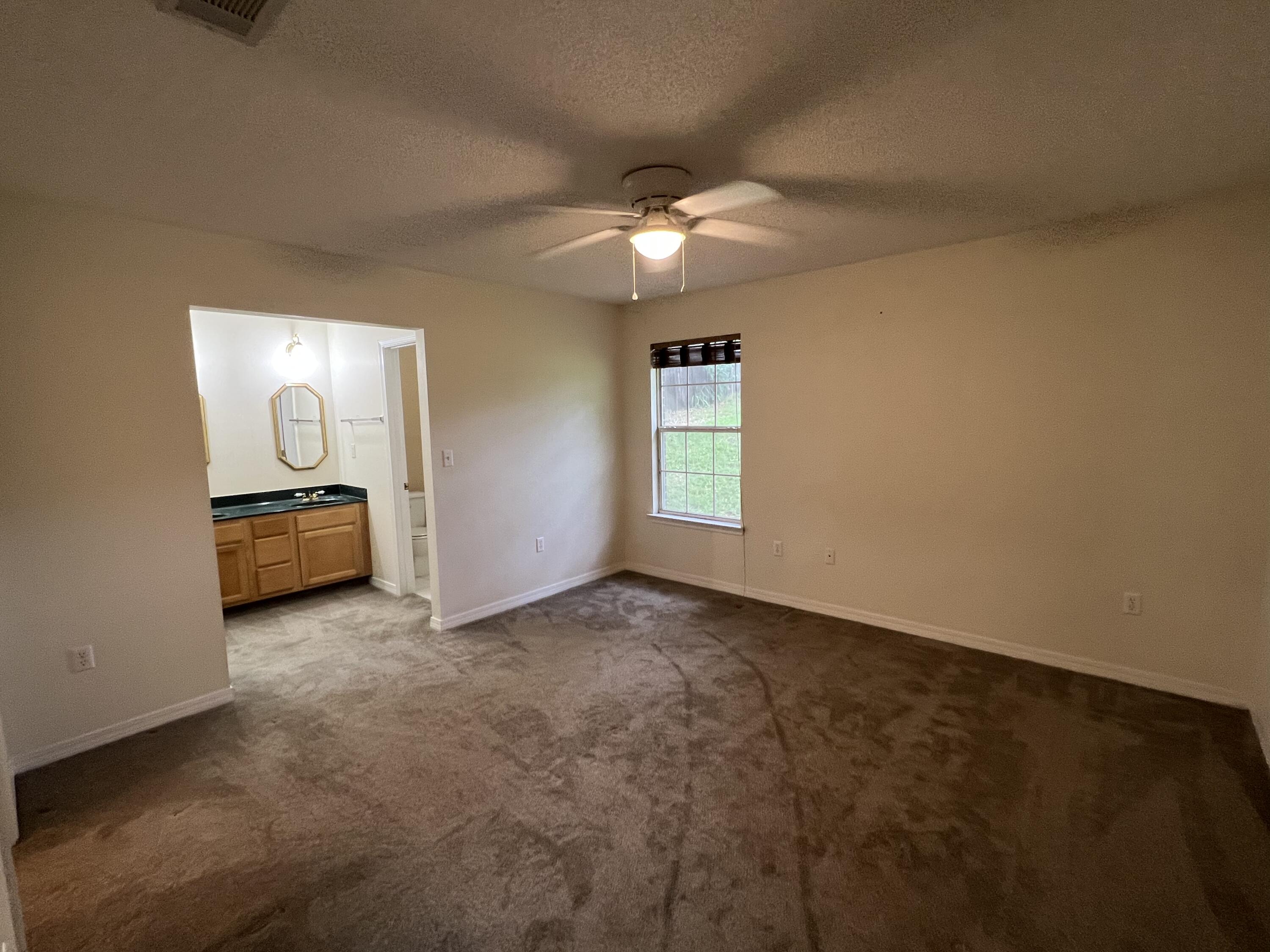 4443 Antioch Road Crestview, FL 32536 - Photo 10 of 24 a view of a livingroom with a ceiling fan and window