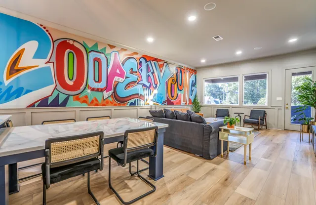 a kitchen with stainless steel appliances granite countertop wooden cabinets a refrigerator and a sink