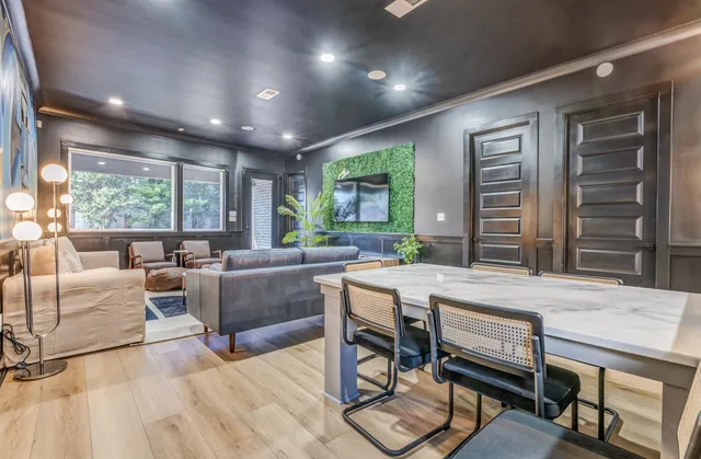 a living room with furniture a large window and a table
