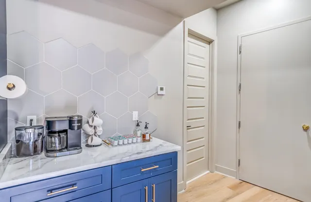 a kitchen with stainless steel appliances kitchen island granite countertop a sink and window
