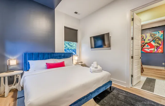 a bedroom with a bed and a painting on the wall