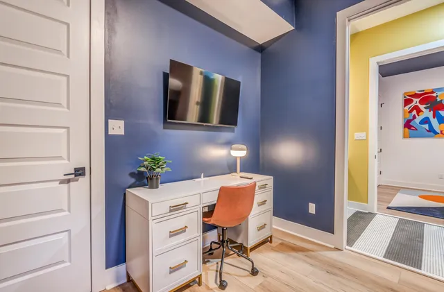 a bedroom with a bed and a desk