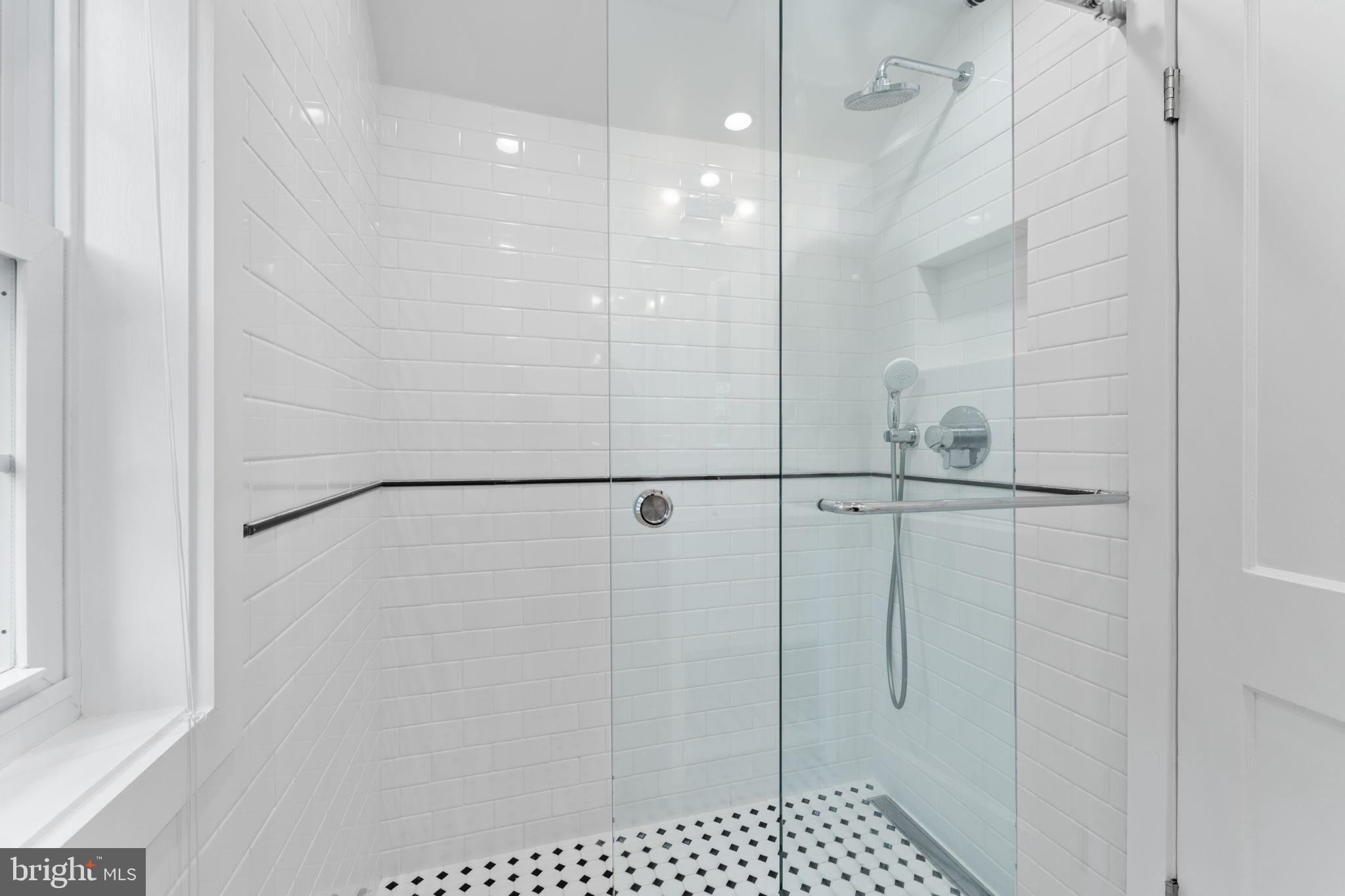 1214 West Braddock Road Alexandria, VA 22302 - Photo 20 of 39 Sleek glass shower with modern design.