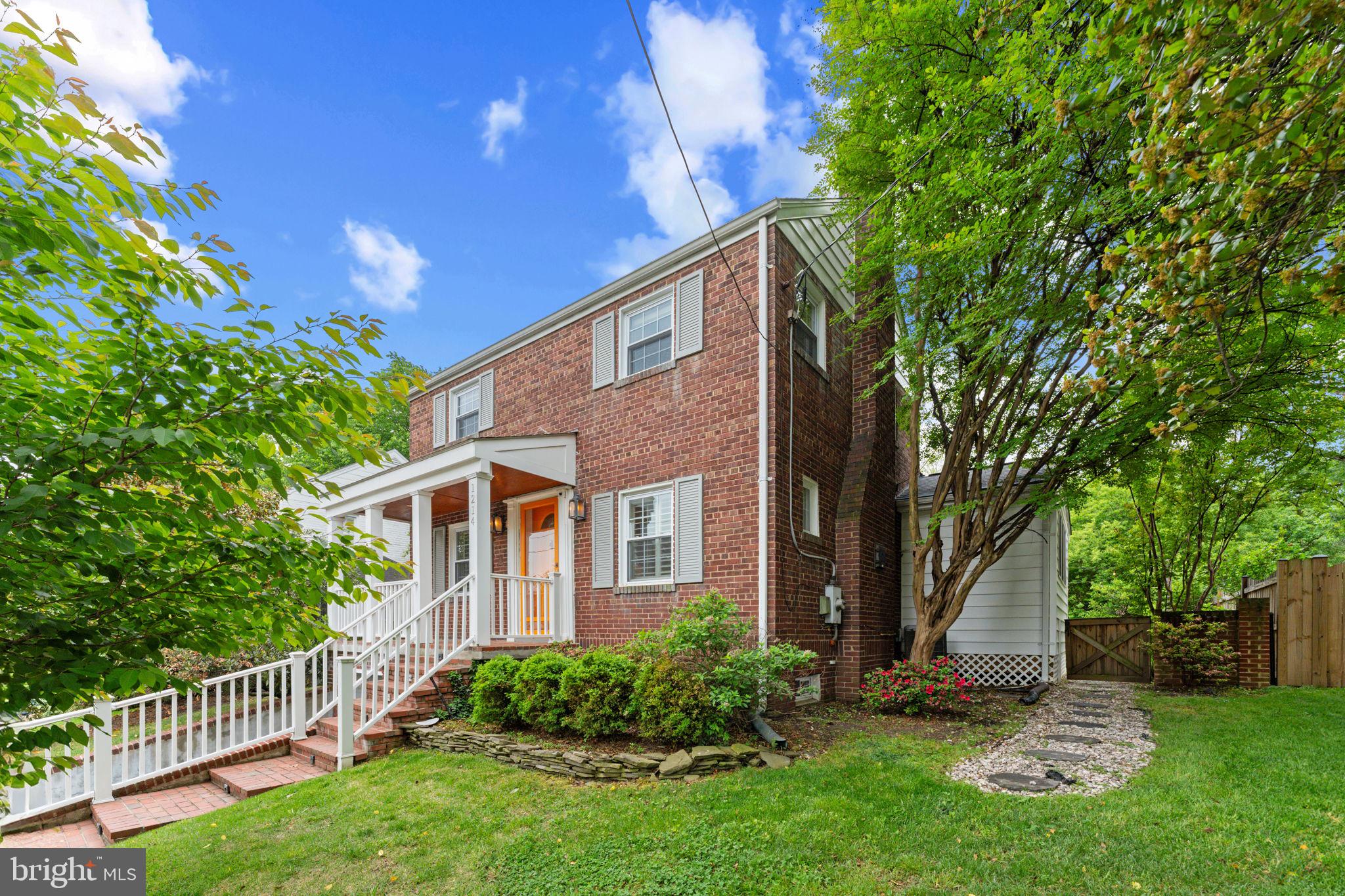 1214 West Braddock Road Alexandria, VA 22302 - Photo 2 of 39 Charming brick home with lush greenery.