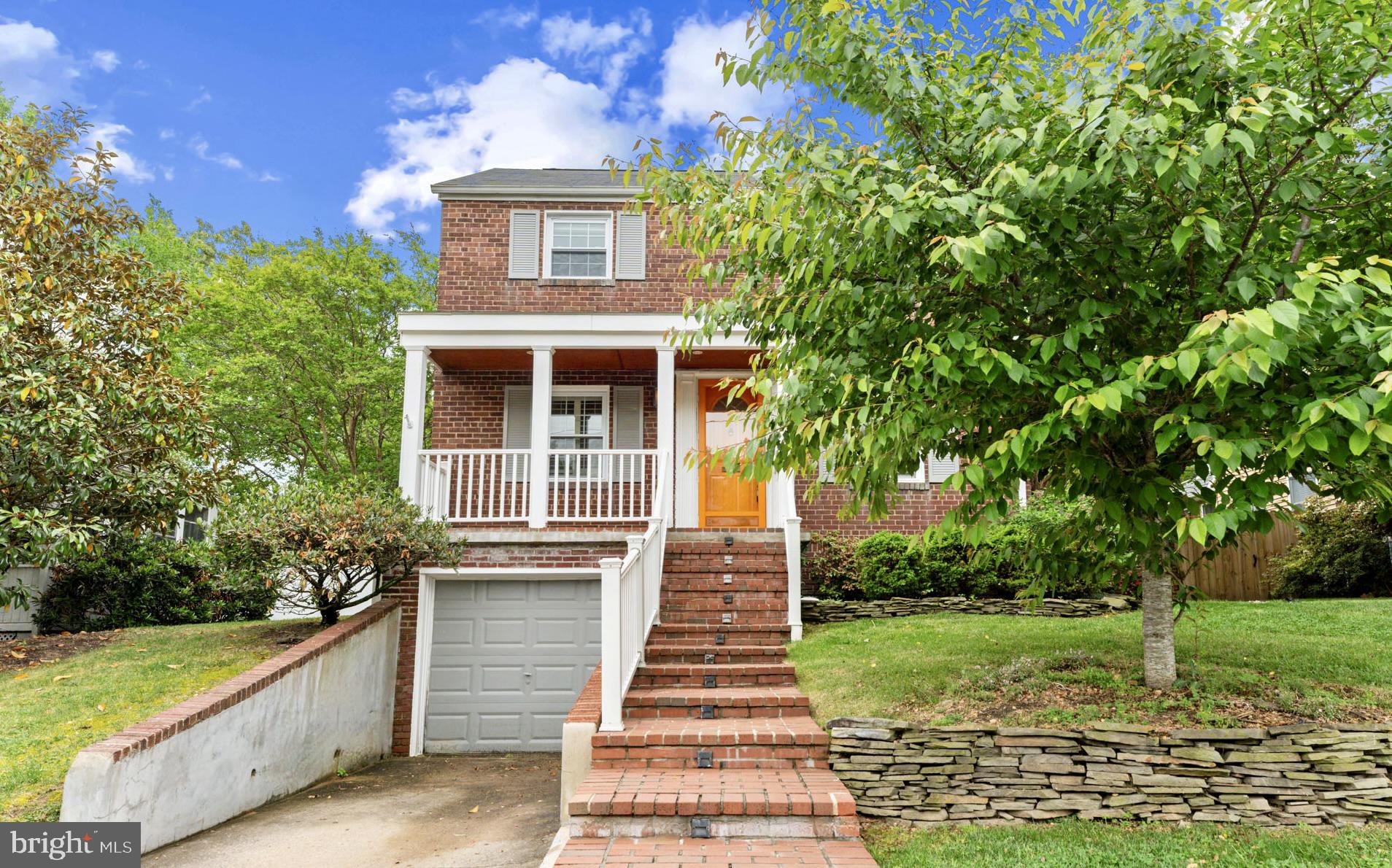 1214 West Braddock Road Alexandria, VA 22302 - Photo 3 of 39 Charming brick home with lush greenery.