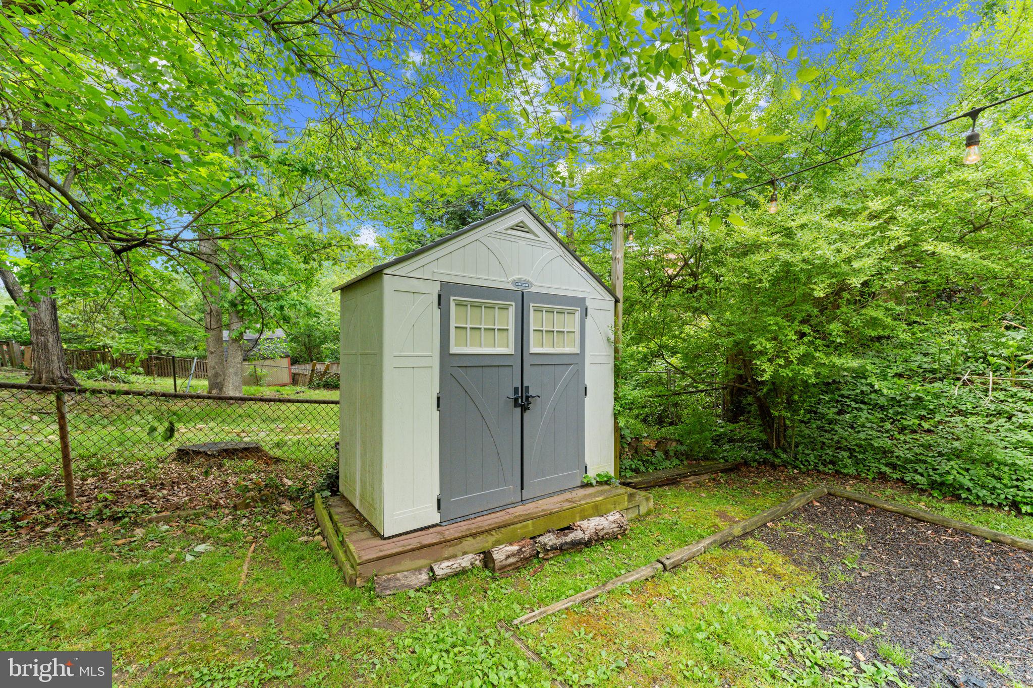 1214 West Braddock Road Alexandria, VA 22302 - Photo 36 of 39 Charming garden shed in lush greenery.