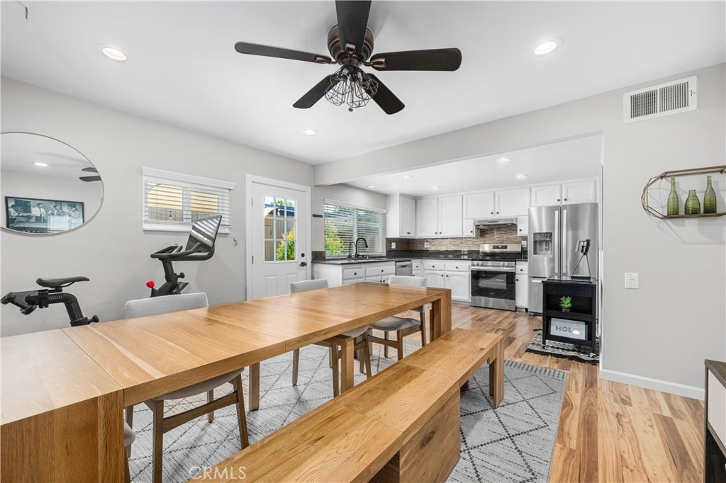 4237 Larwin Avenue Cypress, CA 90630 - Photo 11 of 48 a large kitchen with kitchen island a large counter top space a sink stainless steel appliances and cabinets