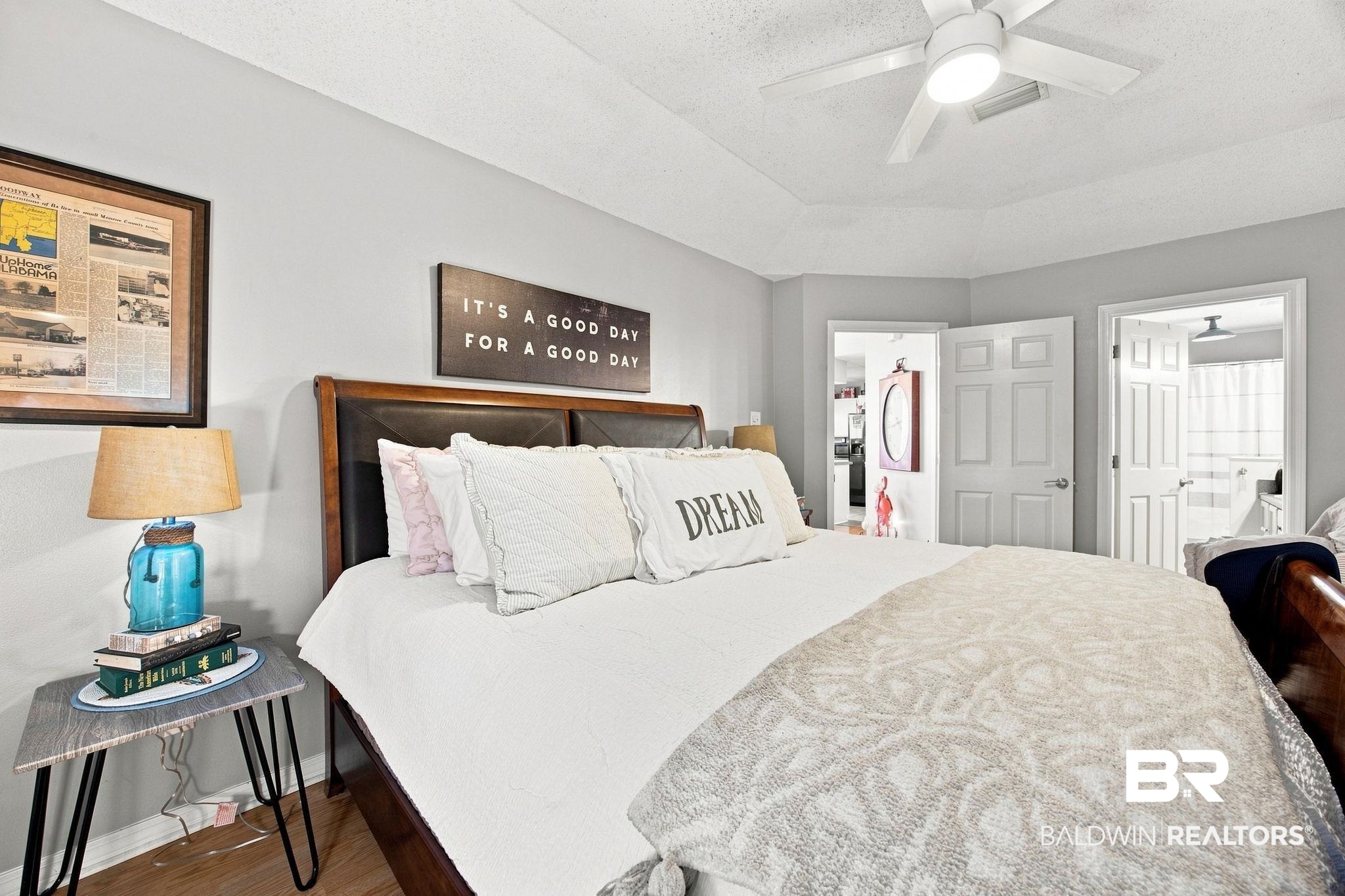 7577 Audubon Drive Foley, AL 36535 - Photo 17 of 33 Bedroom featuring a tray ceiling, ceiling fan, and wood-finish flooring
