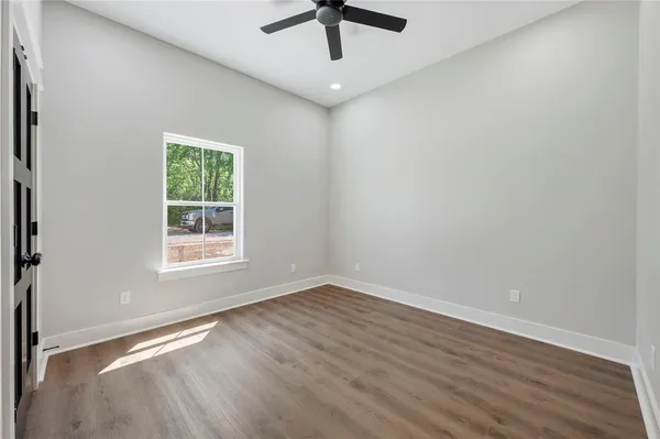 a bedroom with bed and a potted plant